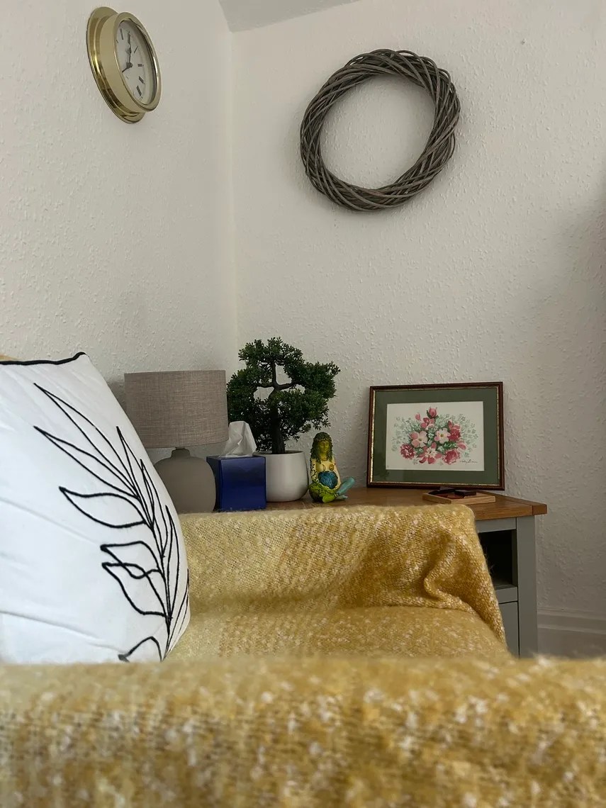 Close up of a comfortable chair and warm, appropriate therapy room decor